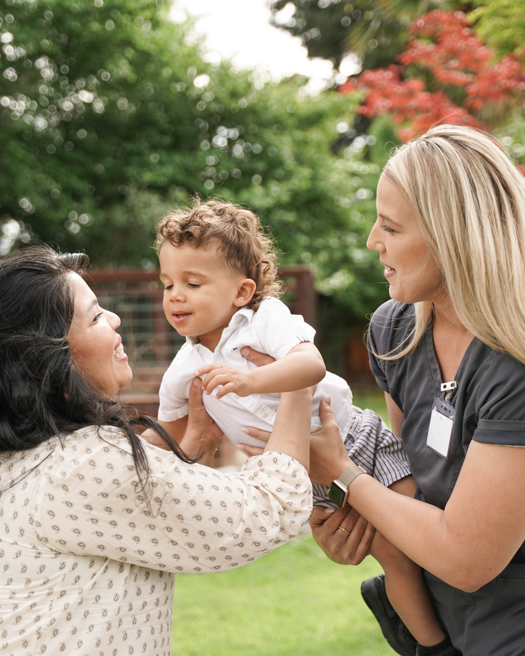 Two people holding a child