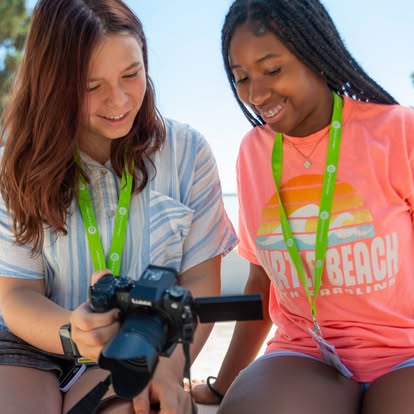 Two teens looking at a camera screen