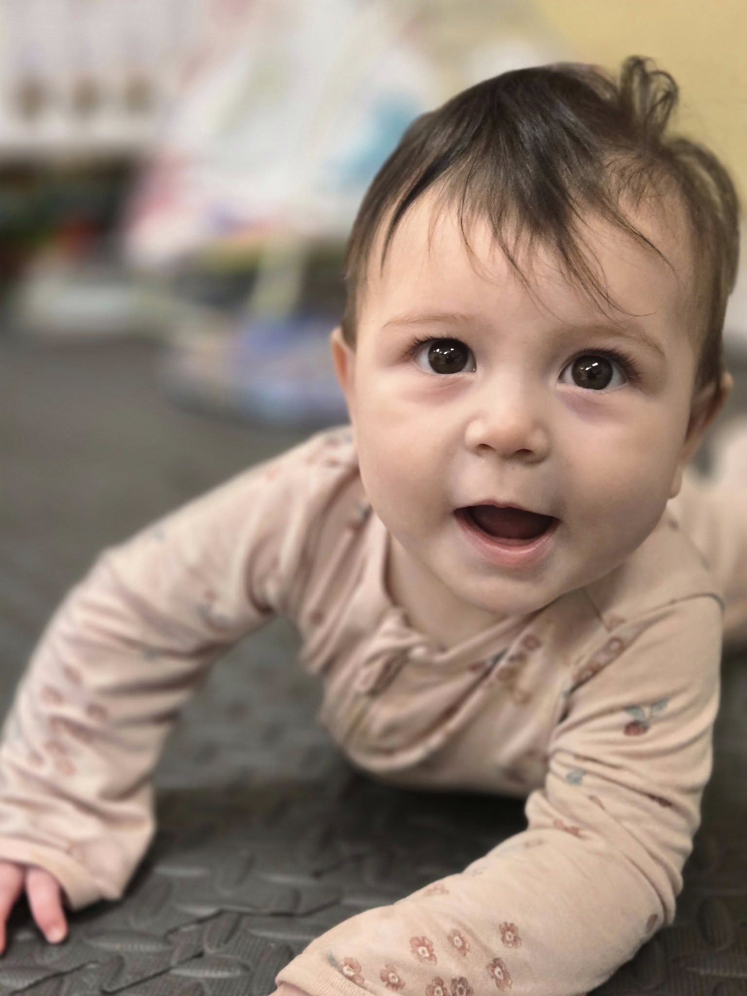 Close-up of a child on their stomach looking up
