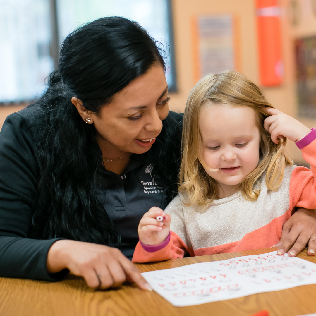 Adult and child looking at paper on a table