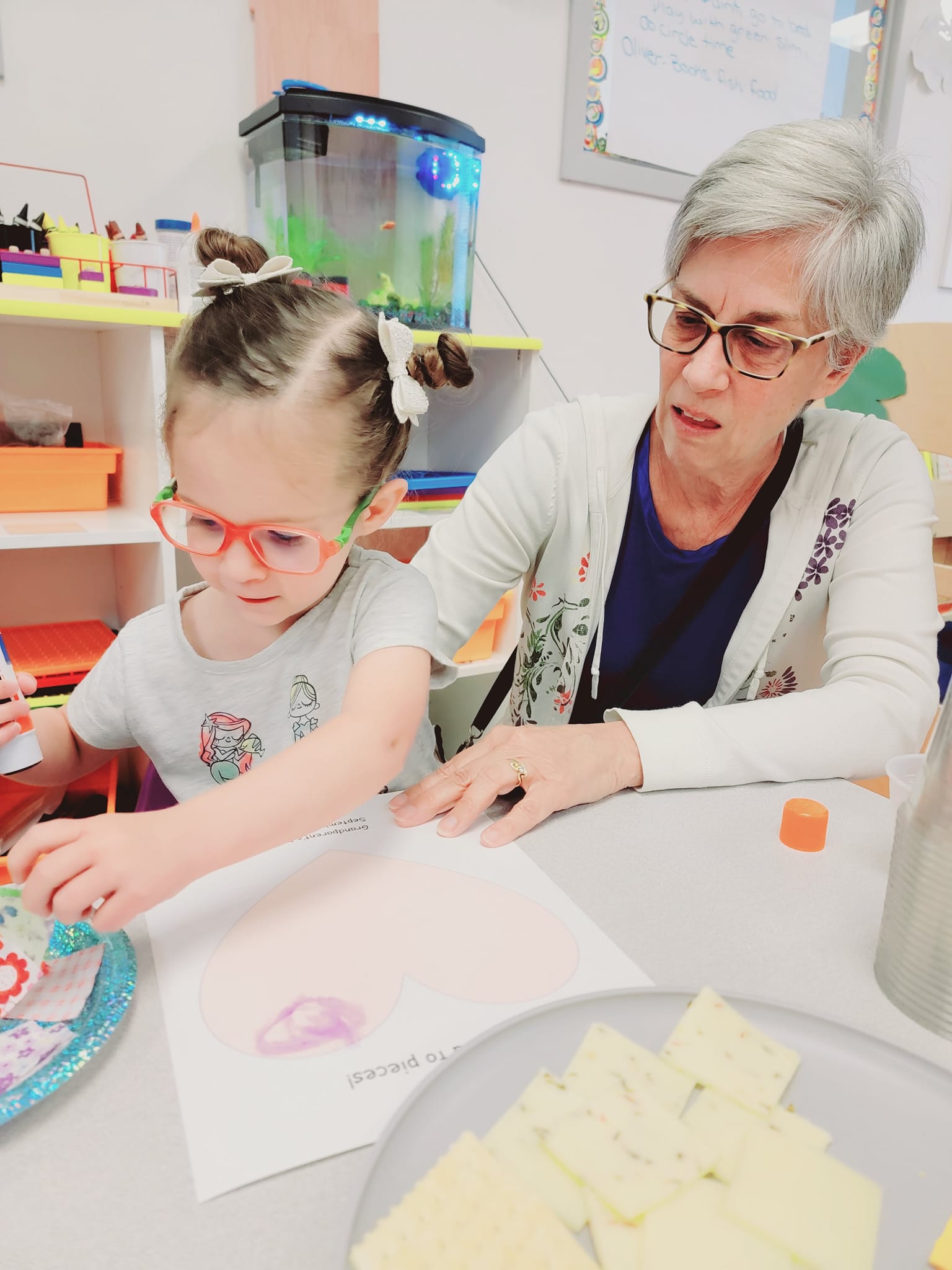 Adult and child doing an art project at a table