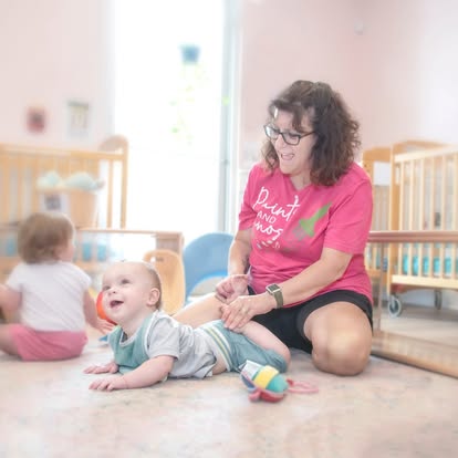 Person on floor with two babies
