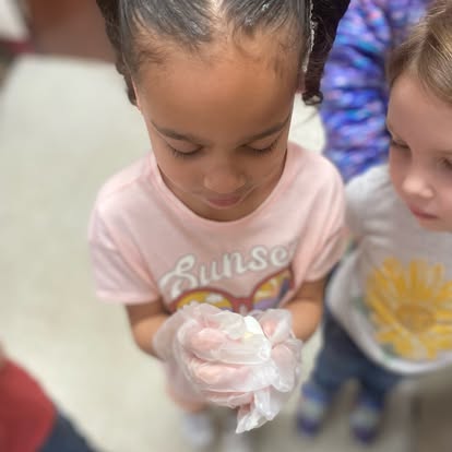 Child wearing gloves and holding something in their hands
