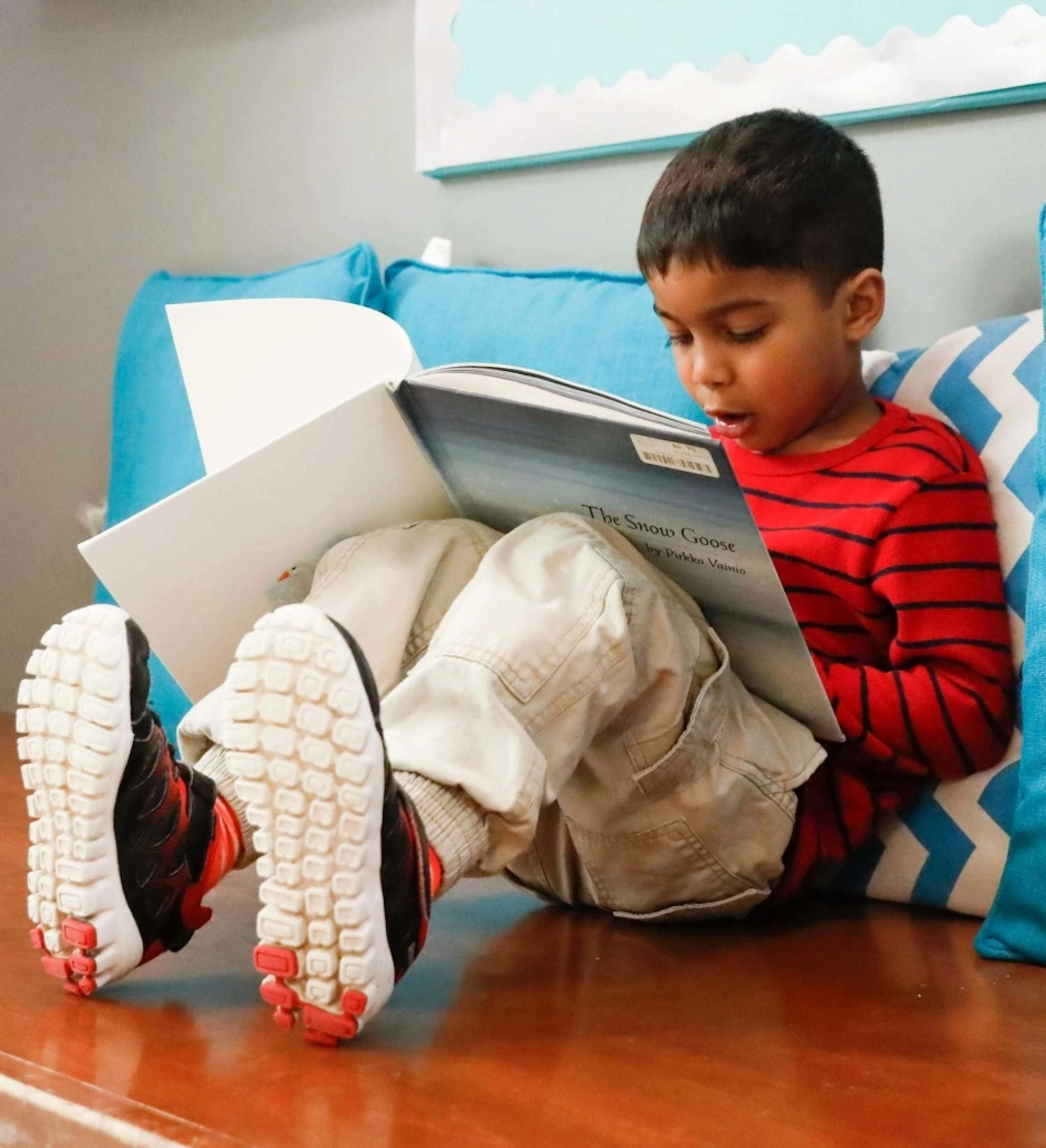 Child sitting and reading a book
