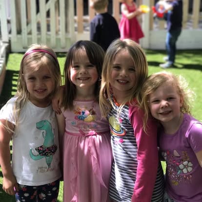 Four children standing together outdoors
