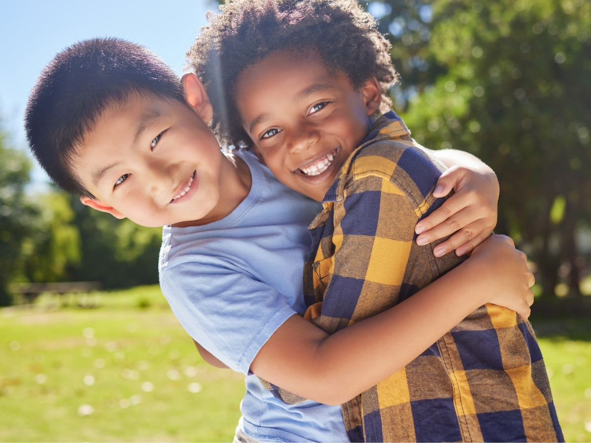 Two children hugging outdoors