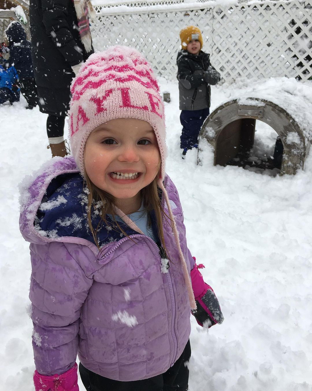 Child in winter coat and hat in the snow