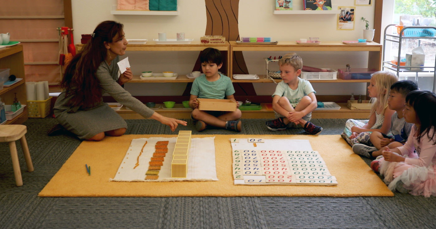 Person teaching children in a classroom