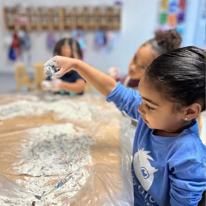 Child playing with flour on a table