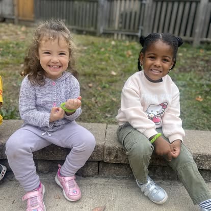 Two children sitting outdoors