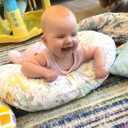 Child on stomach on a patterned pillow