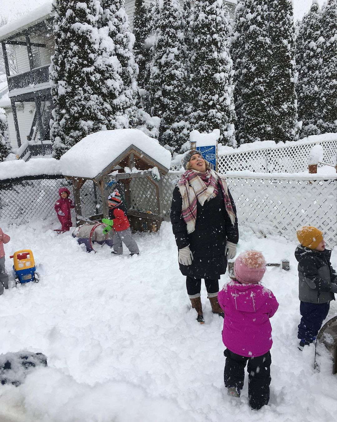 Person and children playing in the snow