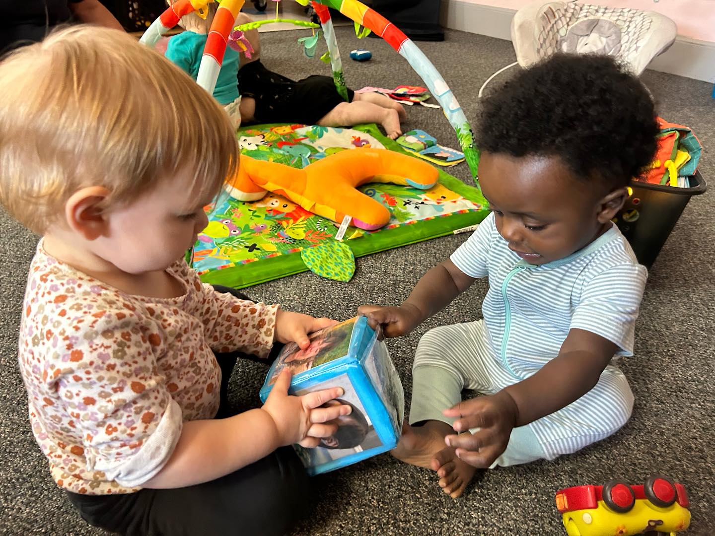 Two children playing with a toy together