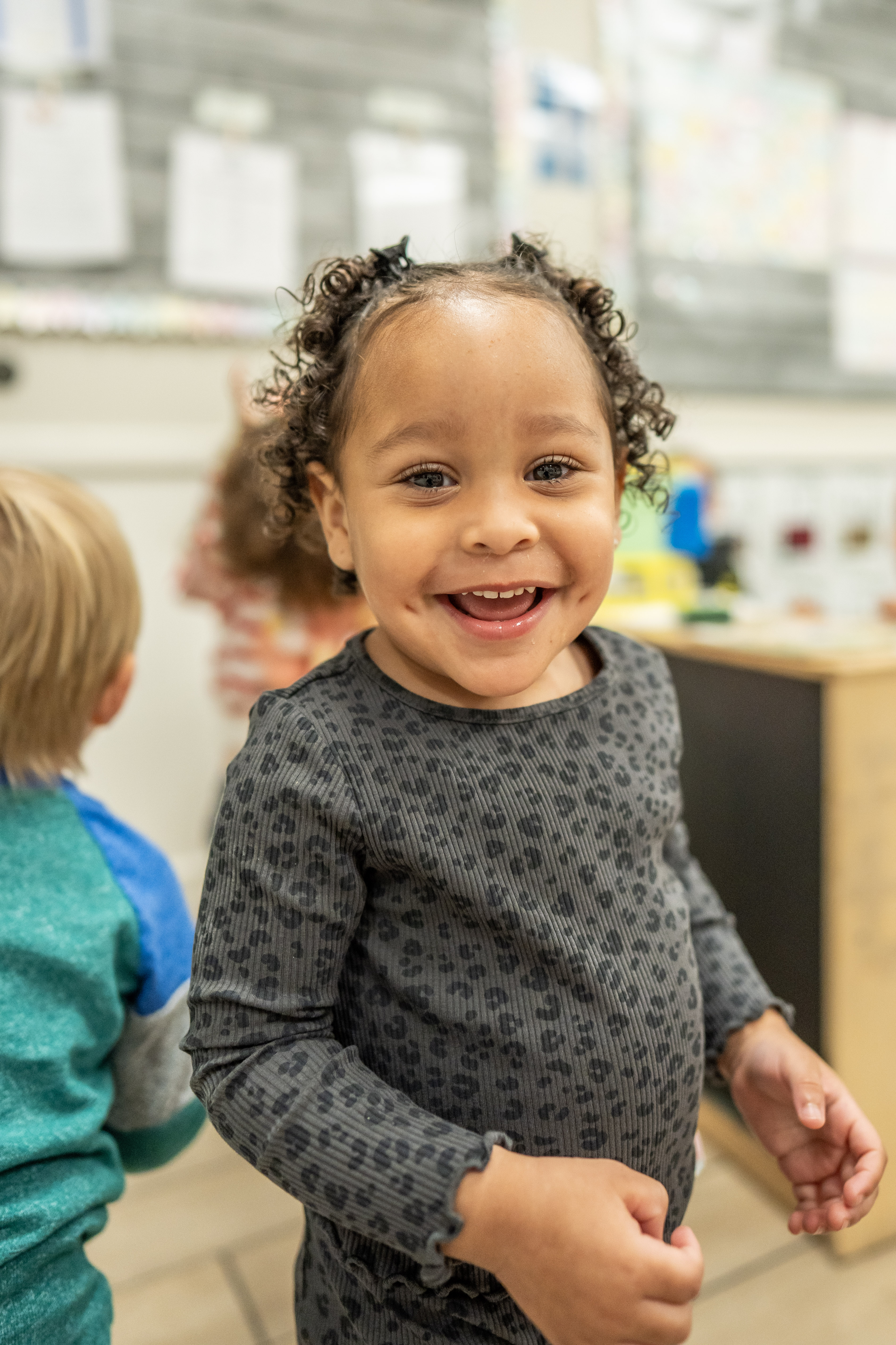 Child smiling in a classroom