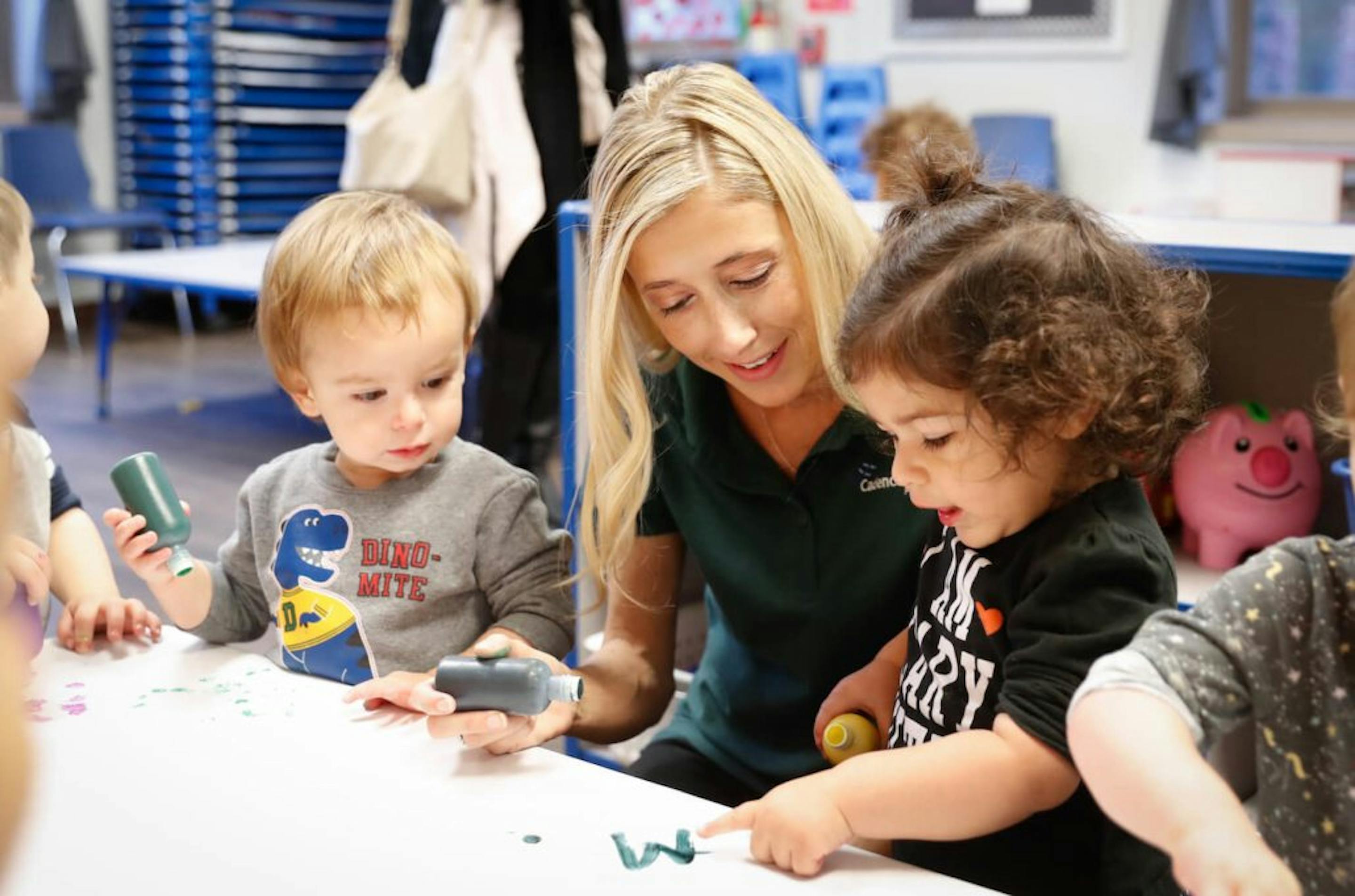Adult and two children playing with modeling clay at a table