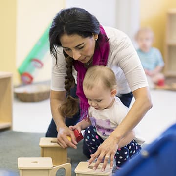Adult and child playing with wooden blocks