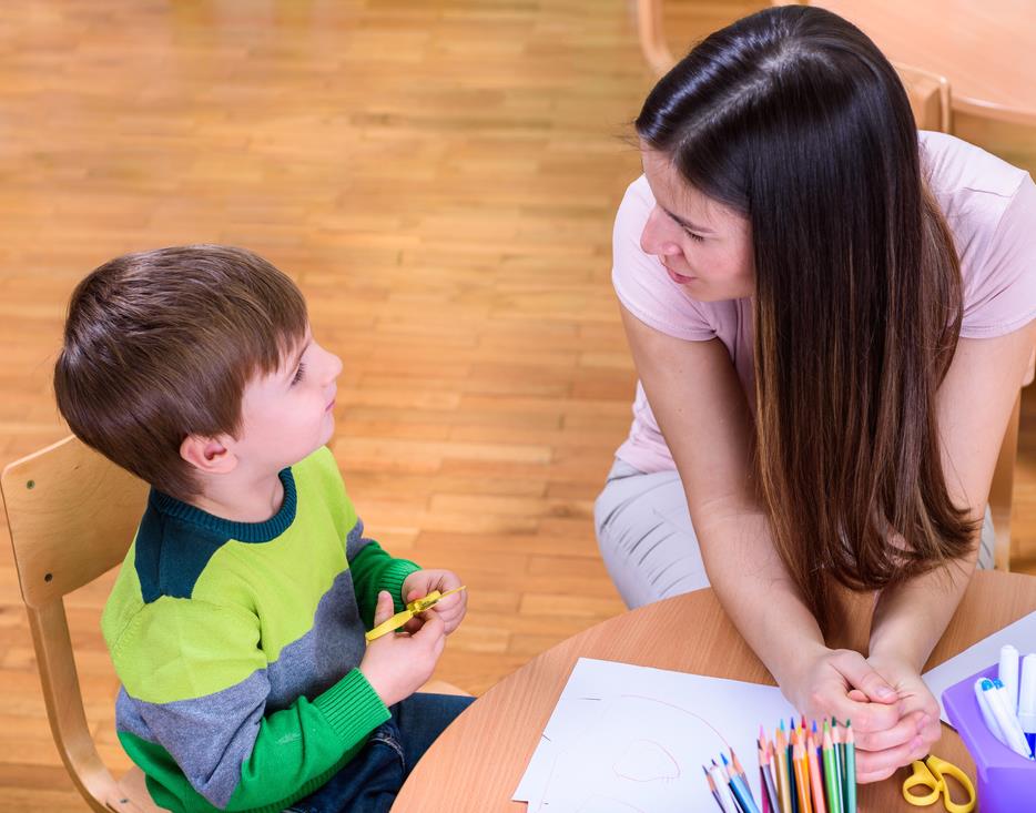 Adult and child at a table with art supplies