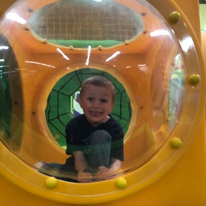 Child in a play tunnel