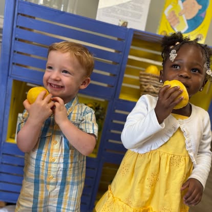 Two children holding lemons