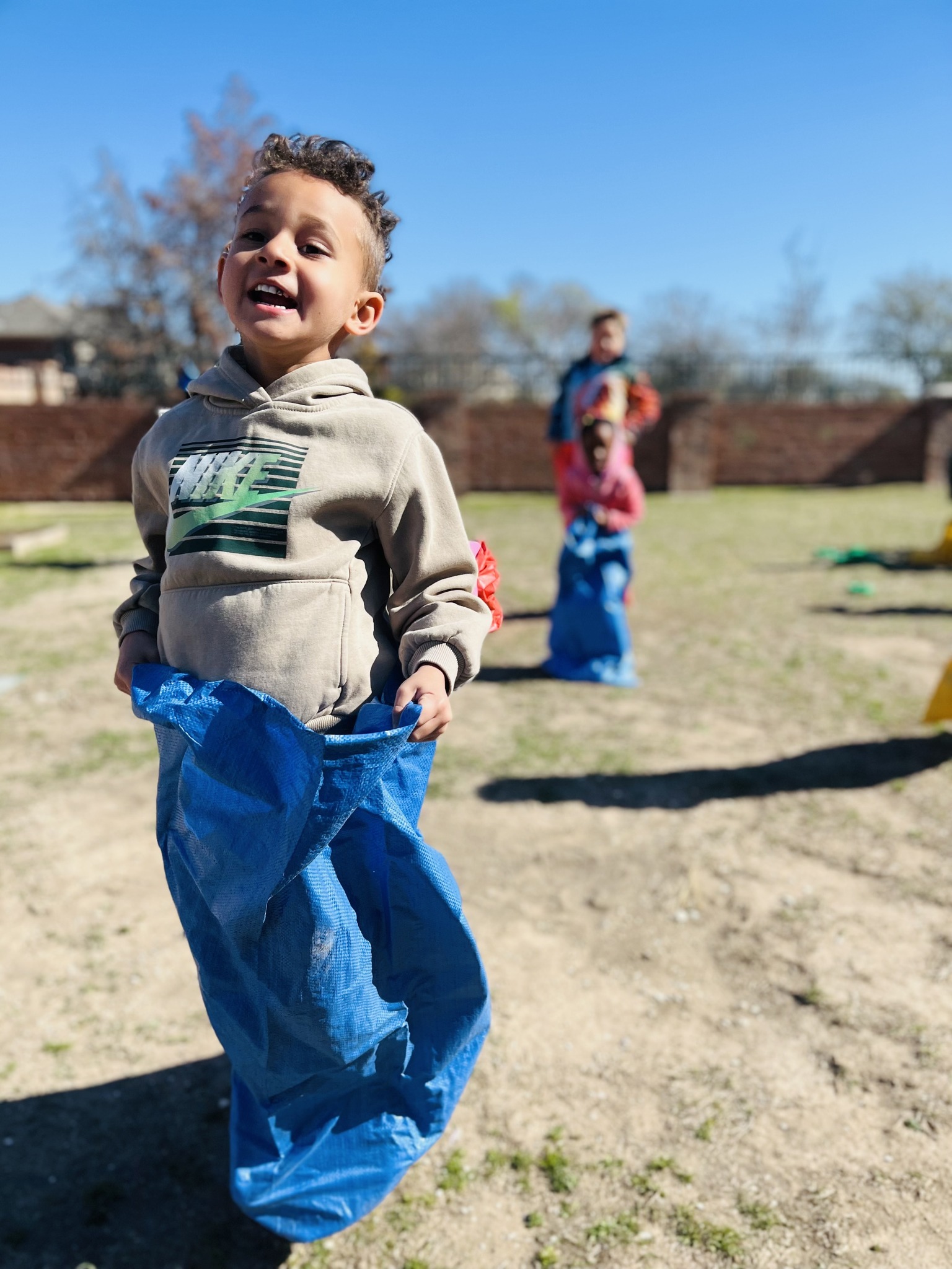 Child in a blue sack for a sack race
