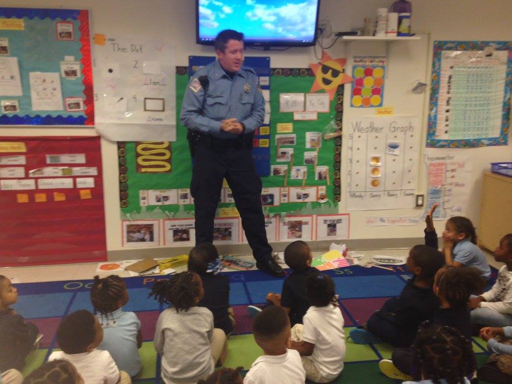 Police officer speaking to children in a classroom