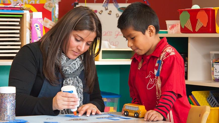 Person and child doing an activity with glue