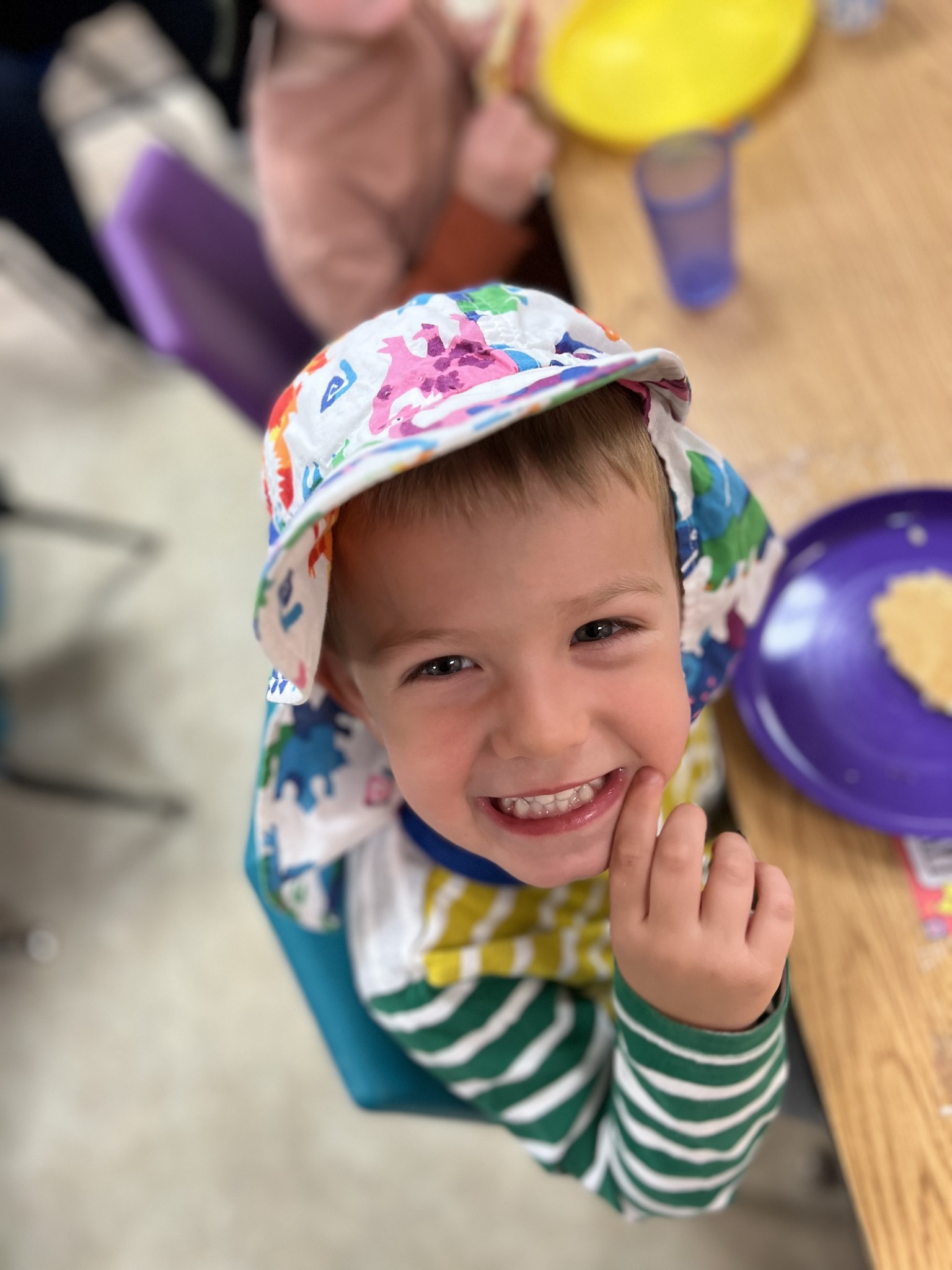 Child in a colorful hat smiling