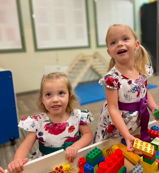 Two children playing with building blocks