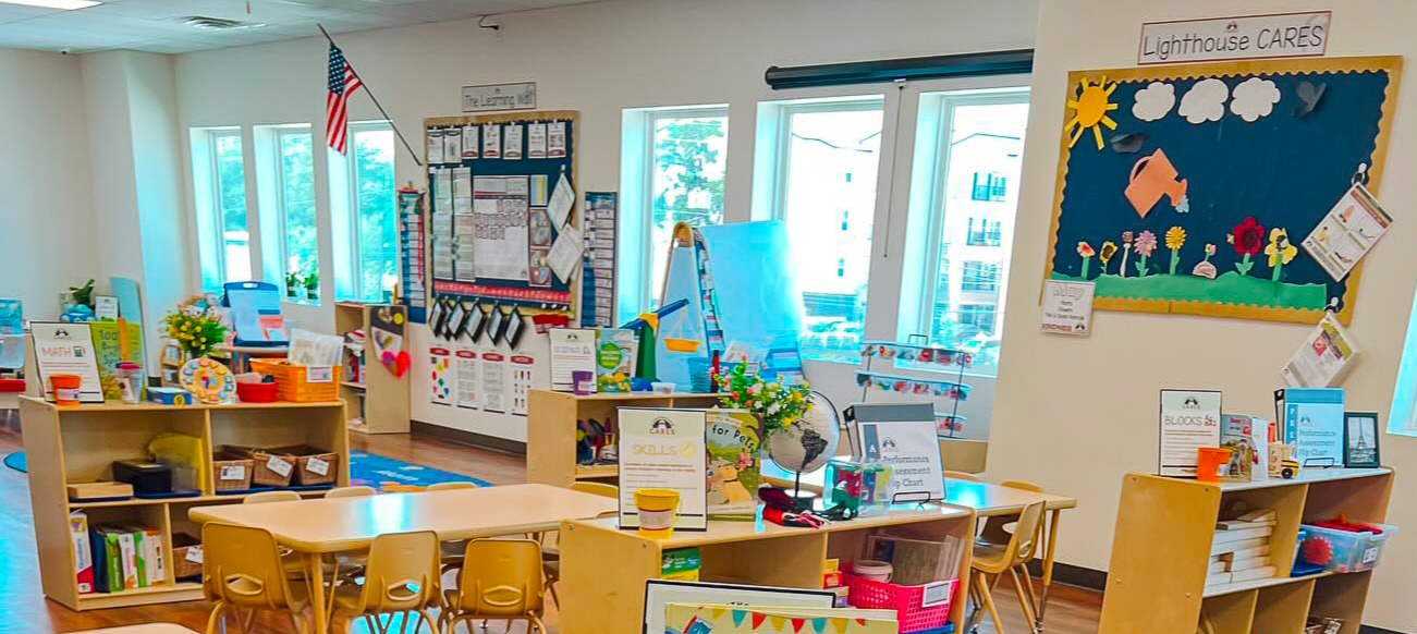 Classroom interior with children's tables, chairs, and educational wall displays