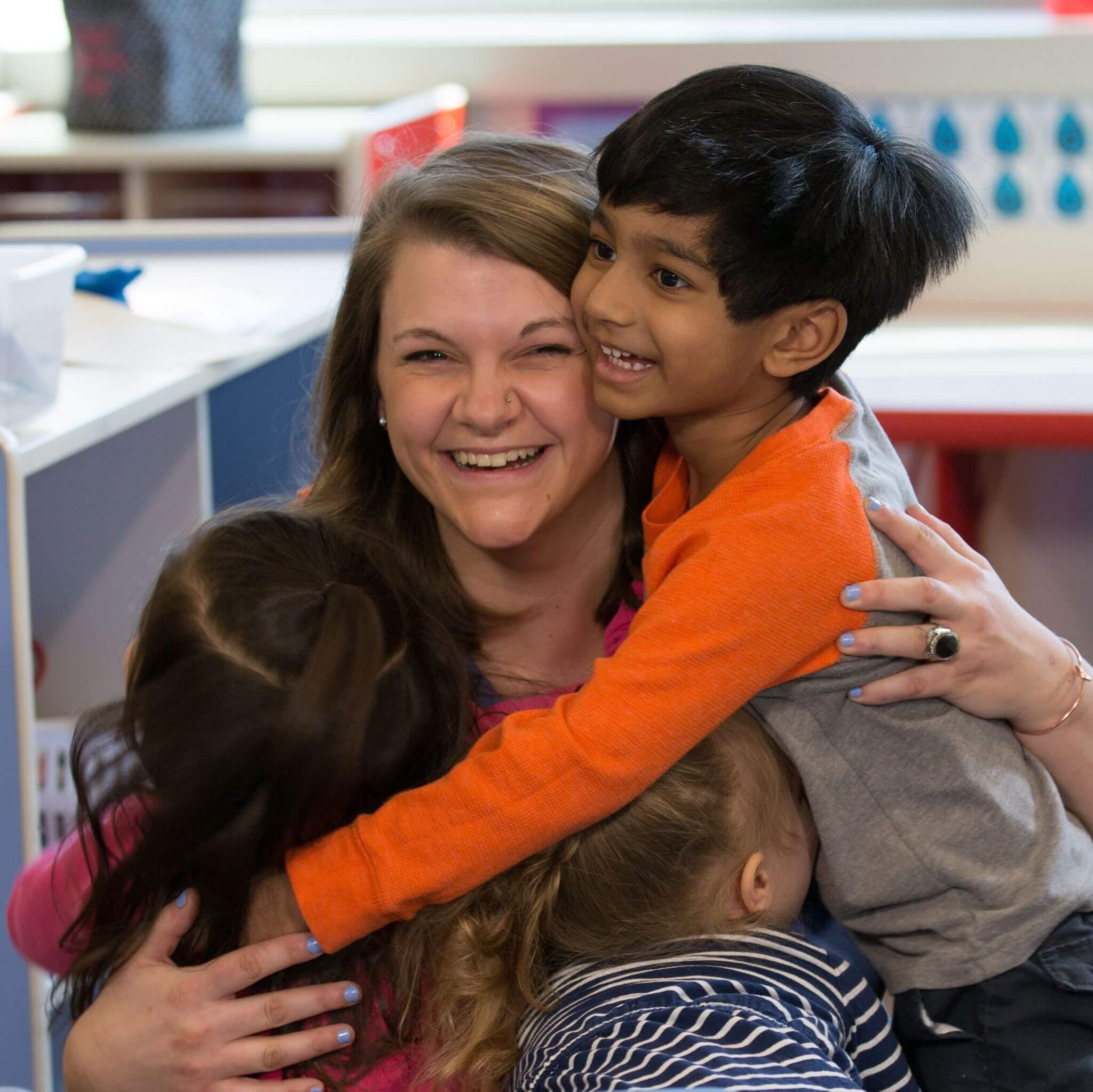 Person hugging two children
