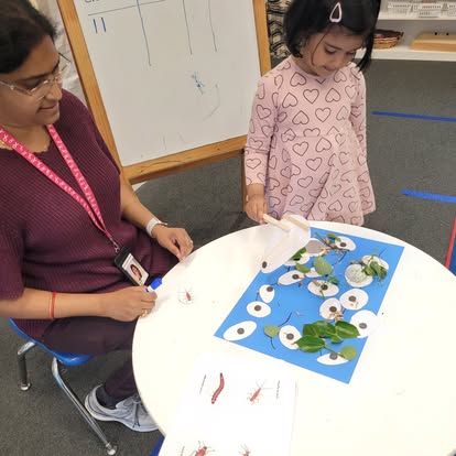 Person and child at a table with craft materials