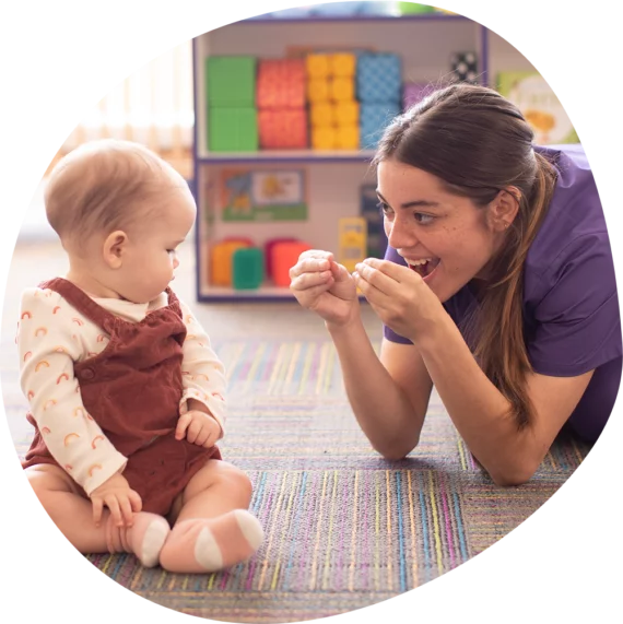 Adult and child on floor interacting on floor interacting
