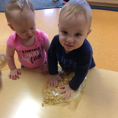 Two children playing with a sensory bag on a table