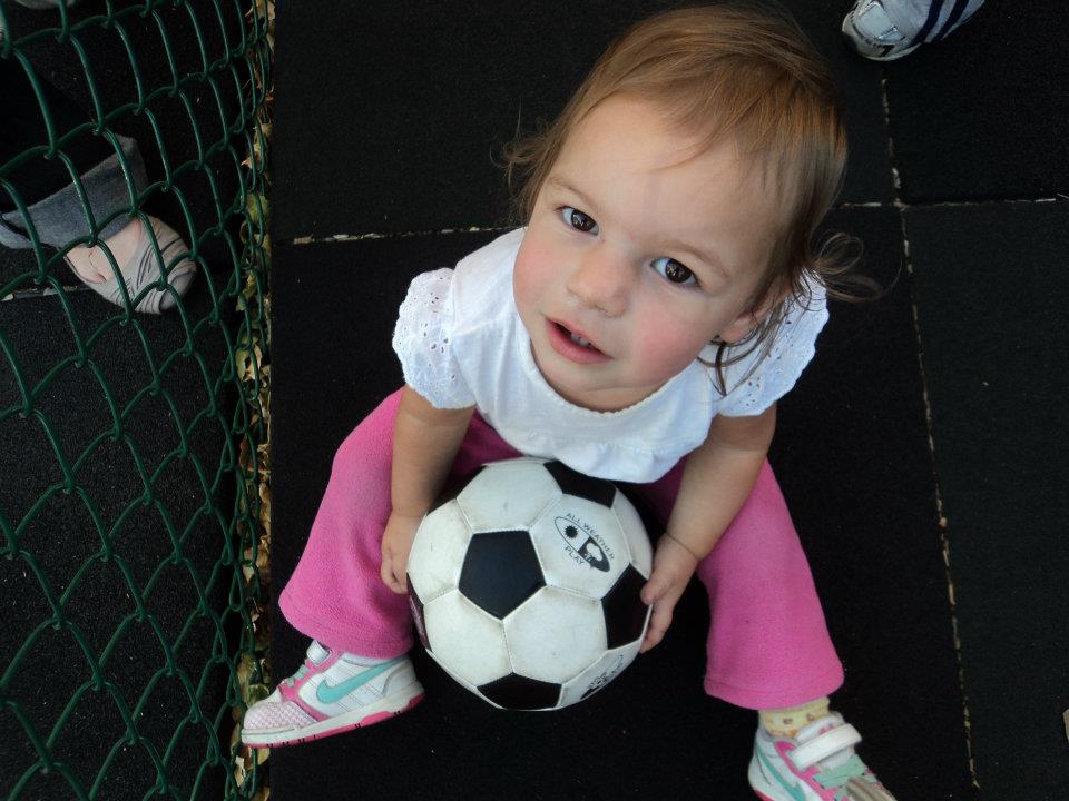 Child holding a soccer ball