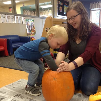 Person and child carving a pumpkin