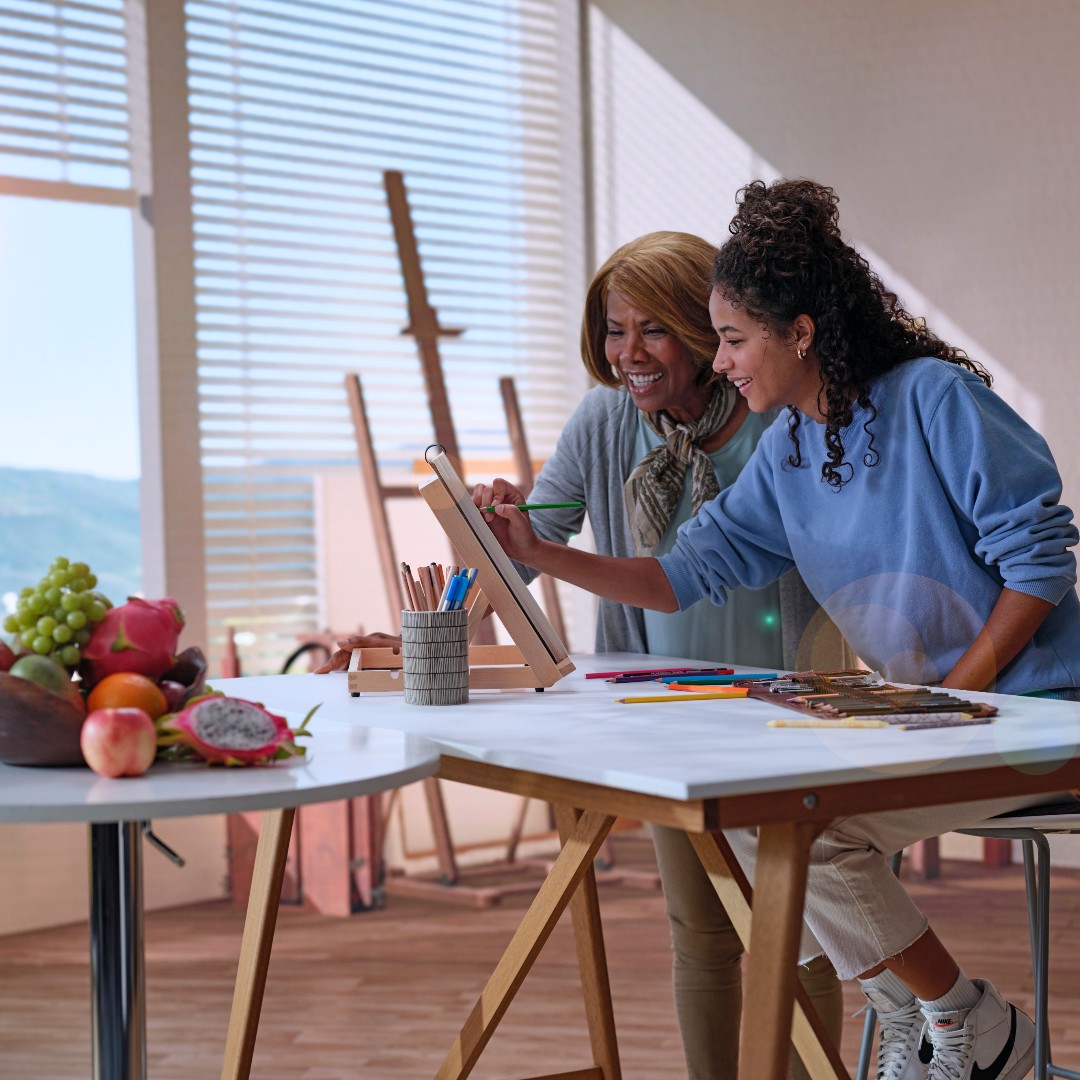 Two people painting at an easel