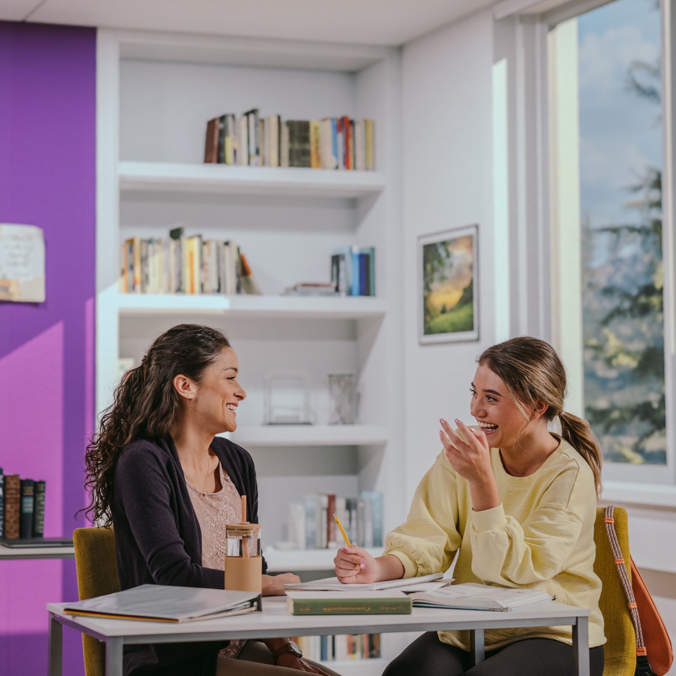 Two people sitting at a table and talking