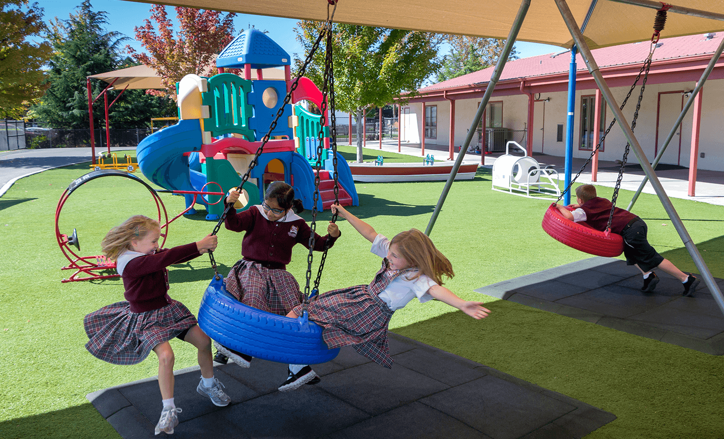 Children playing on swings on a playground