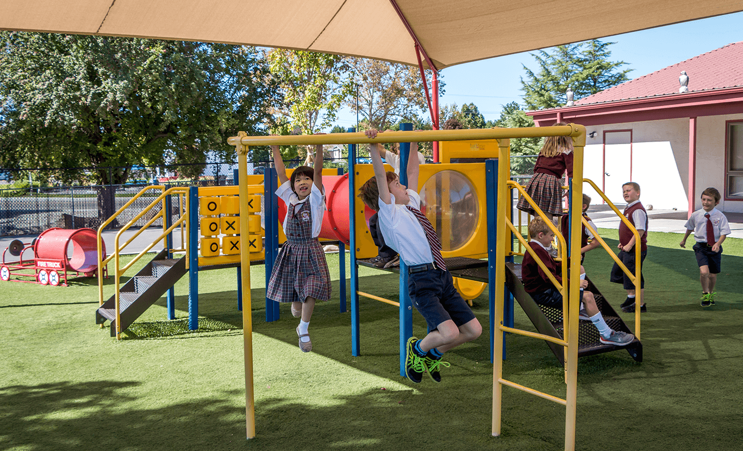 Children playing on monkey bars and playground equipment