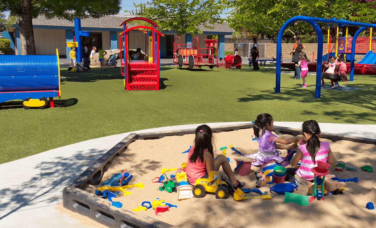 Children playing in a sandbox at a playground
