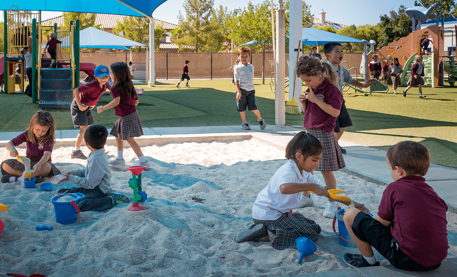Children playing in a sandbox on a playground