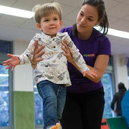 Person helping a child balance