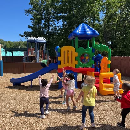 Children playing on a colorful playground structure