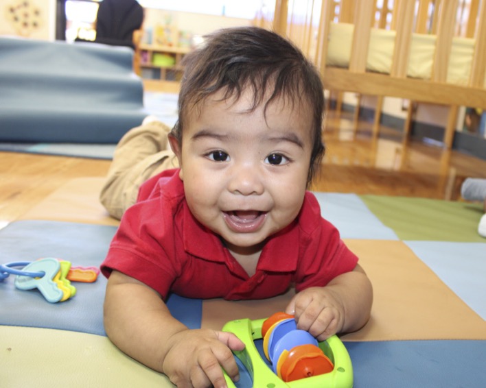 Child on floor holding a toy
