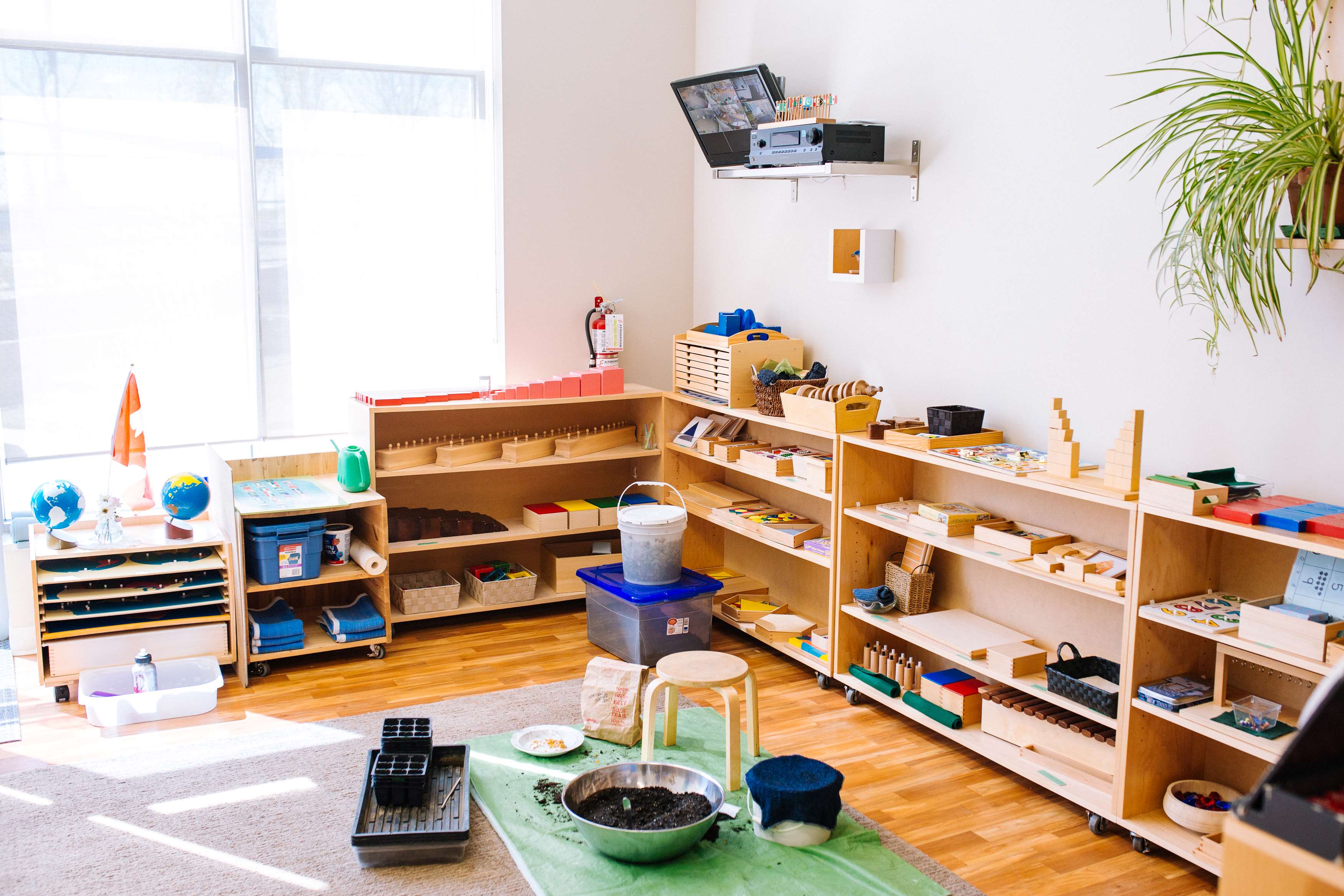 Classroom with wooden shelves filled with learning materials