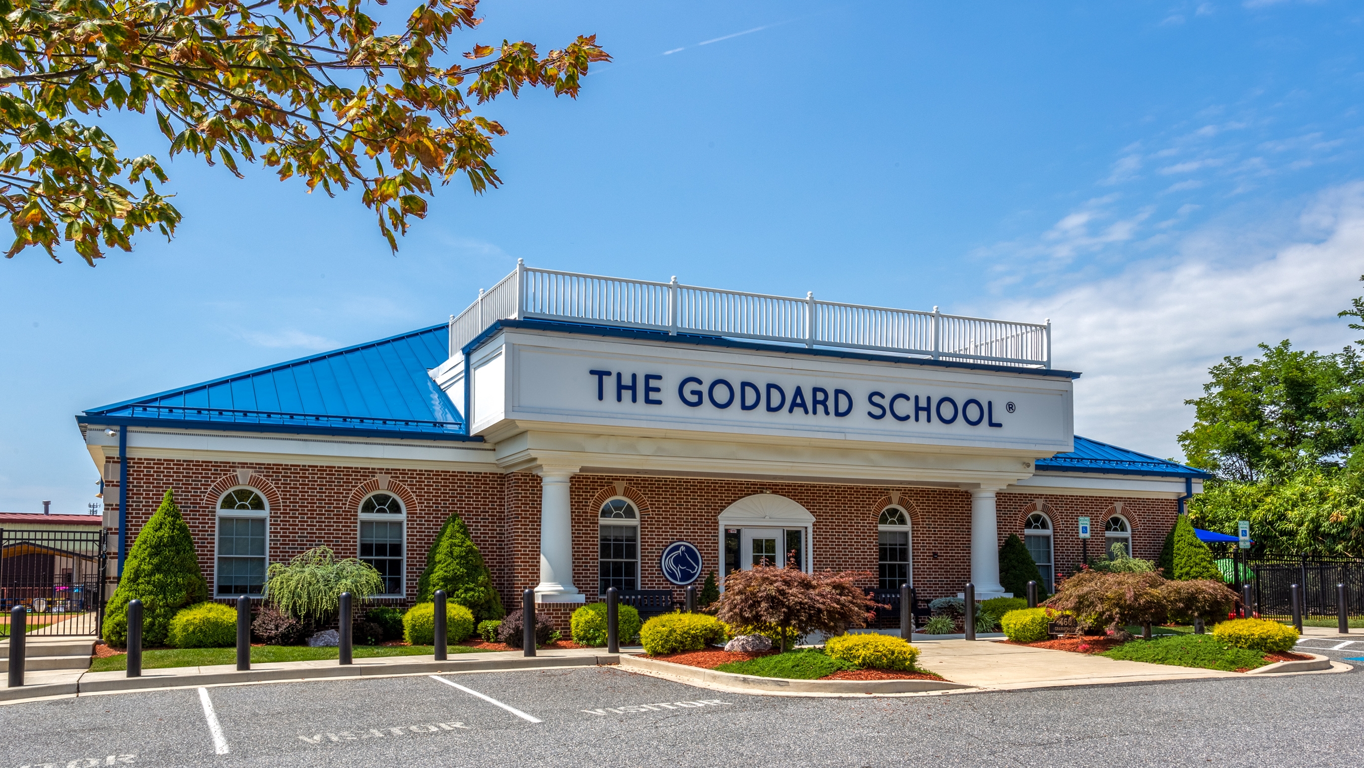 The Goddard School building exterior with blue roof and landscaping