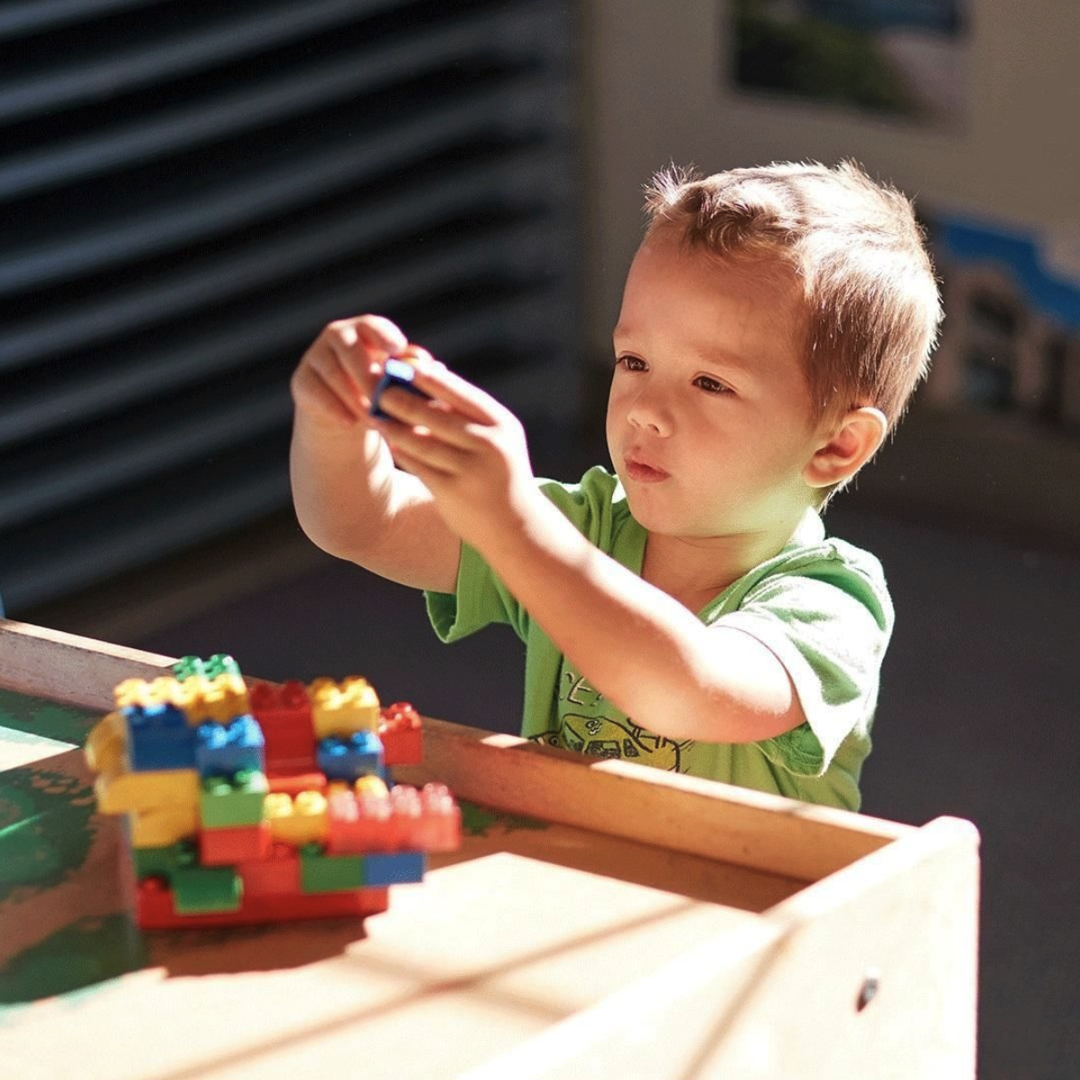 Child playing with colorful building blocks