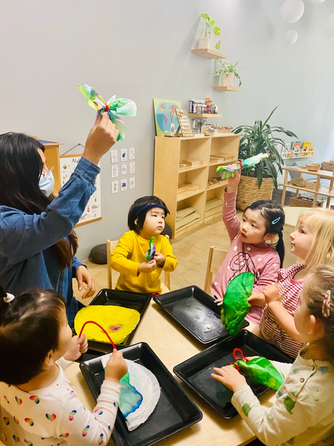 Adult and children making crafts at a table
