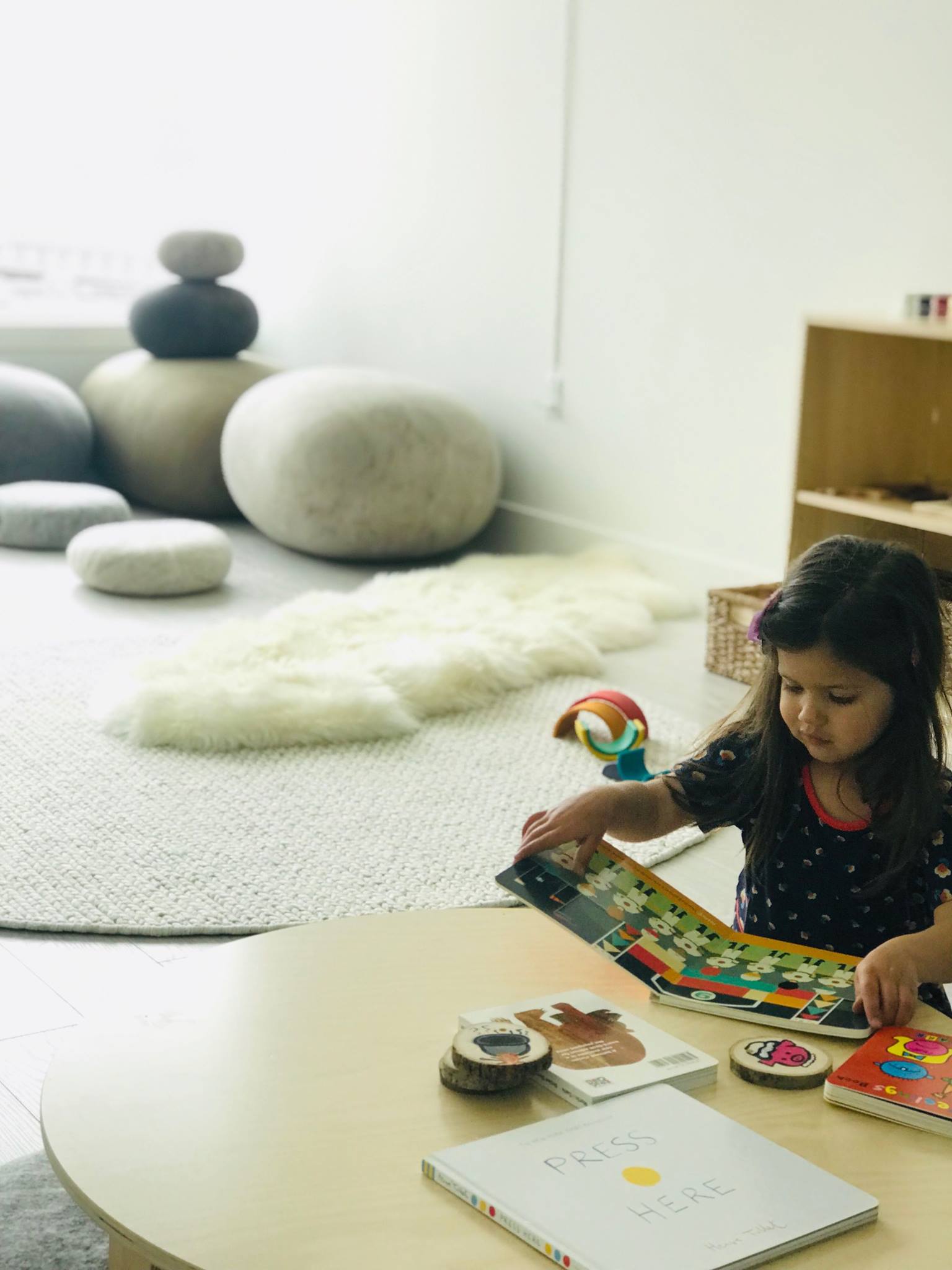 Child looking at a book at a table